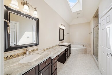 The primary bathroom has updated granite counters