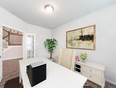 Behind the gorgeous glass french doors tucked away is an office with wood tile floors, and large windows that let in plenty of natural light. Your perfect long awaited private reading room or work space.