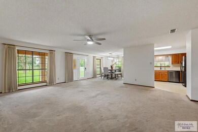Living area with view to kitchen & dining