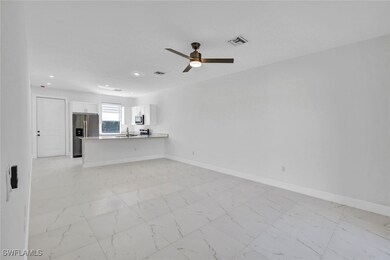 Unfurnished living room featuring baseboards, a si