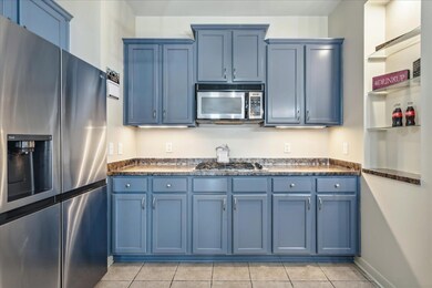 Kitchen featuring light tile patterned floors, app