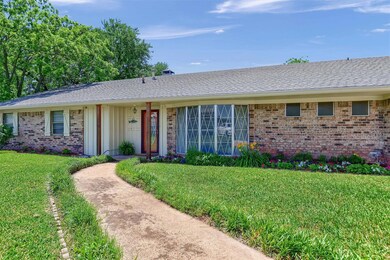 Ranch-style home featuring a front lawn