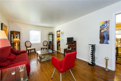 Living room leads to open kitchen and dining space