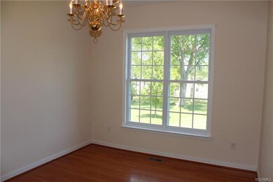 The dining room also features wood floors, a two-t