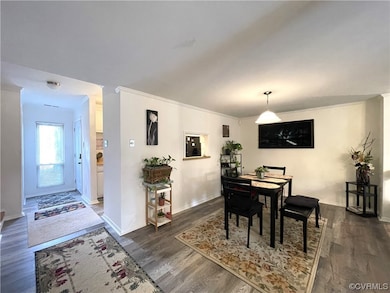Dining area with dark hardwood / wood-style floori