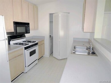 Kitchen, laundry closet in the rear of the photo