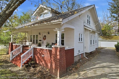 Bungalow-style house with covered porch and a garage