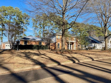 View of front of home featuring brick siding and a