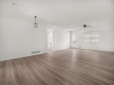 Spare room with wood finished floors, a textured c