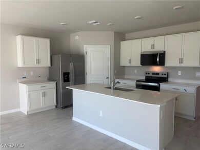 Kitchen with appliances with stainless steel finis