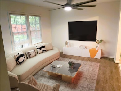 Living room featuring wood finished floors and a ceiling fan