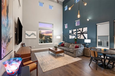 Living room with a towering ceiling, baseboards, a