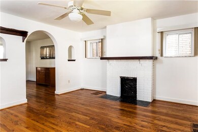 Cozy, decorative fireplace enhances the feel of this ample sized family room.