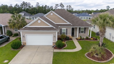 View of front of home with concrete driveway, stone siding, an attached garage, roof with shingles, and a front lawn