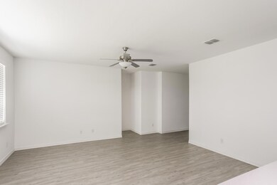Empty room with light hardwood / wood-style floors and ceiling fan