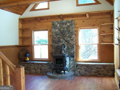 Hardwood floors and walls with natural rocks adorn the living room. The replica (ornamental) stove adds the feeling of warmth without an actual fire. The soaring ceilings are reminiscent of your favorite ski lodge.