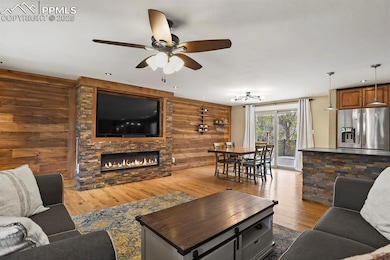 Living area featuring wood walls, dark wood-style 