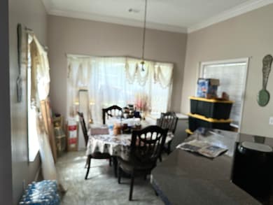 Dining room featuring ornamental molding and radia