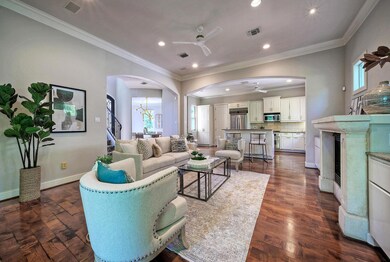 Living area with dark wood-type flooring, arched 