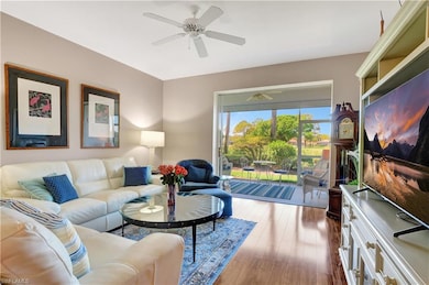 Living area featuring ceiling fan and wood finishe