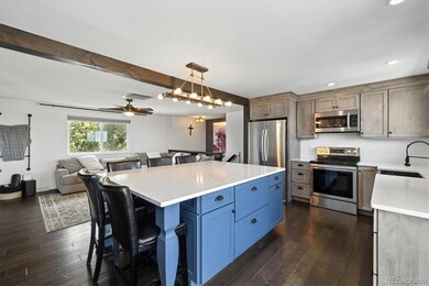 Beautiful open kitchen with solid surface countertops, new cabinets and stainless appliances. The refrigerator is included!