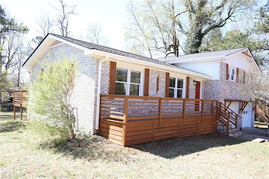 View of front of home with brick siding and a wood