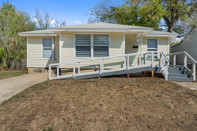 View of front of property with a front yard and a wooden deck