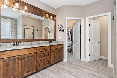 Double vanity with framed mirror and granite tops.