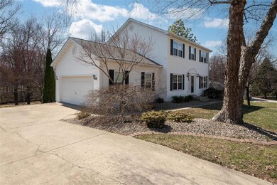 Colonial home with concrete driveway and a garage