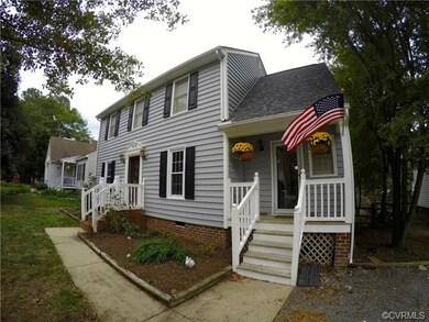 Sweet, front sitting porch that leads to the kitch