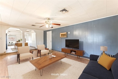 Living area with arched walkways, wood finished fl