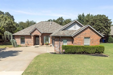 View of front of property with brick siding, a front yard, concrete driveway, and roof with shingles