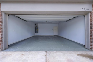 Garage featuring electric water heater and basebo