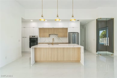 Kitchen featuring freestanding refrigerator, moder