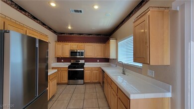 Kitchen with stainless steel appliances, a sink, l