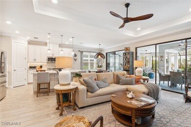 Living area with a raised ceiling, light wood fini