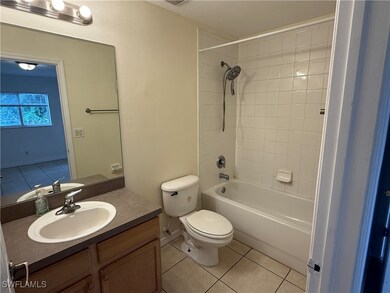 Full bath featuring tile patterned flooring, toile