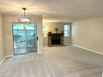 Living room featuring light carpet, a fireplace, a