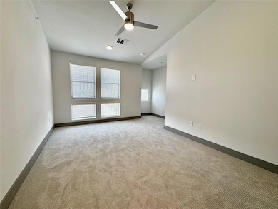 Carpeted empty room featuring visible vents, ceili