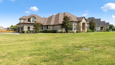 Spacious front yard with 3 car garage
