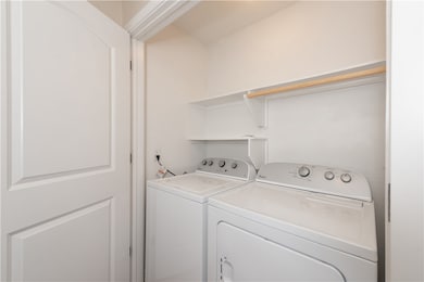 Clothes washing area featuring washer and dryer an