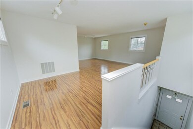 Stairs from front door and entrance to private garage space.