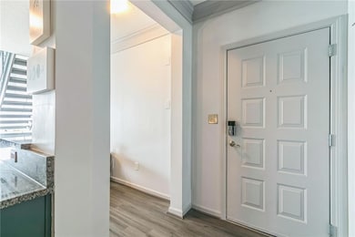 Foyer entrance featuring hardwood / wood-style flo