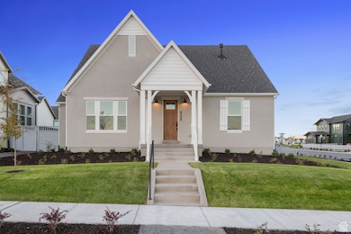 View of front facade with stucco siding and a shingled roof