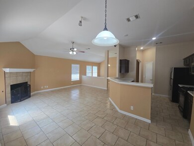 Unfurnished living room with vaulted ceiling, a ceiling fan, light tile patterned flooring, a fireplace, and recessed lighting