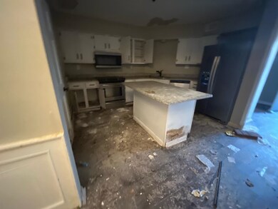 Kitchen featuring stainless steel fridge, sink, wh