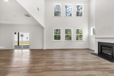 Soaring two story family room with tons of natural light
