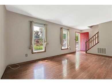Family room with wood floors and a coat closet.