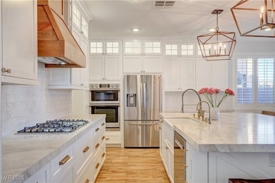 Kitchen with stainless steel appliances, ventilati
