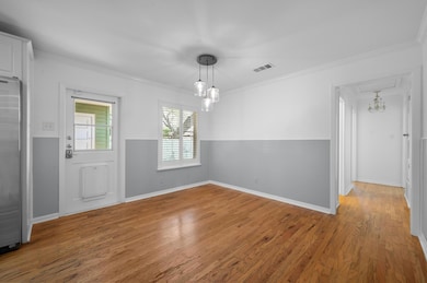 Unfurnished dining area featuring wood finished f